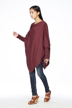 "🚚..ALL ORDERS ARE SHIPPED VIA DHL EXPRESS MAIL This batwing tunic is a very \"cool\" addition to any wardrobe! With a unique drawstrings on bottom hem of tunic provide plenty of options for changing the look. Cowl neckline, batwing sleeves with wide cuffed and oversized side pocket; can be worn layered over leggings, pants, or skirt for even more dramatic effects. * Pull-on style * Cowl neckline * Dropped shoulders * Long sleeves with wide ribbed cuff * Oversize side pocket * Asymmetrical hem Winter Plain Top With Asymmetrical Hem, Fall Tops With Asymmetrical Hem For Layering, Spring Solid Color Long Sleeve Poncho, Fall Tops For Layering With Asymmetrical Hem, Fall Layering Tops With Asymmetrical Hem, Solid Color Slouchy Top For Fall, Slouchy Solid Color Top For Fall, Oversized Sweater With Asymmetrical Hem, Oversized Winter Top With Asymmetrical Hem