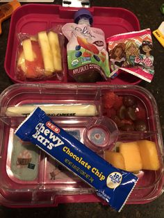 two plastic trays filled with different types of food and snacks on top of a table