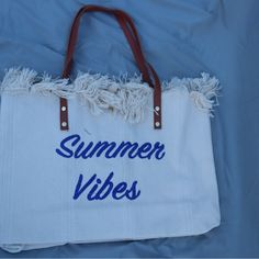 New With Tags Great Tote Size White Bag With Summer Vibes Embroidered In Navy Blue Material: Canvas Snap Closure 18.9 In (L) X 4.33 In (W) X 13.39 In (H) White Summer Canvas Shoulder Bag, Trendy White Beach Bag With Adjustable Strap, Casual Embroidered Tote Beach Bag, White Large Capacity Shoulder Bag For Beach Season, Trendy White Canvas Bag For Summer, Large Capacity White Shoulder Bag For Beach Season, Casual White Embroidered Canvas Bag, Summer Travel Embroidered Bags, Beige Embroidered Beach Bag