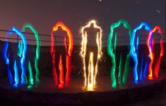 several different colored lights in the shape of people