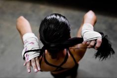 a woman with black hair and white gloves on top of her head, looking down at the ground