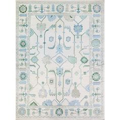 a white rug with blue and green designs on the bottom, in front of a white background