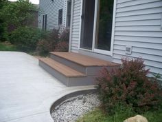 an outside view of a house with steps leading to the front door