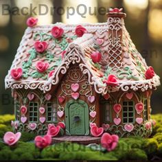 a gingerbread house with pink flowers and hearts on it