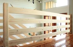 an unfinished bed frame in a room with hard wood flooring and white paint on the walls