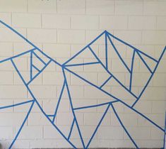 a white brick wall with blue lines drawn on it