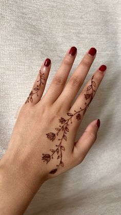 a woman's hand with tattoos on it