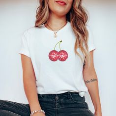 Introducing our Cherry Disco Ball Tee - a sweet and sassy homage to retro glamour and playful vibes. This tee seamlessly fuses the timeless allure of cherries with the glitz of a disco ball, creating a must-have addition to your wardrobe that radiates fun and style. Crafted from soft, comfortable fabric, this tee is perfect for those who appreciate a touch of nostalgia with a modern twist. The design features a vibrant and eye-catching disco ball adorned with whimsical cherries, capturing the essence of carefree nights and energetic dance floors. The playful combination of elements makes it a standout choice for any casual outing or a night of revelry. Machine wash inside out with like colors. Tumble dry on low to medium heat. Do not iron directly on image. Please refer to size chart for r Trendy Crew Neck T-shirt With Cherry Print, Red Crew Neck T-shirt, Sweet Red Crew Neck Top, Sweet White Crew Neck Top, Sweet White Short Sleeve T-shirt, Spring Y2k Relaxed Fit T-shirt, Spring Y2k Style Relaxed Fit T-shirt, Y2k Style Relaxed Fit T-shirt For Spring, White Sweet T-shirt With Funny Print