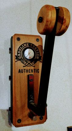 an old fashioned wooden phone is hanging on the wall next to a black telephone cord