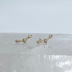 Three Round Cut Diamond 14k gold Stud Earrings made to resemble Orion's Belt. Can be made with yellow gold or rose gold.  * Metal: 14k Yellow Gold, 14k Rose Gold * Gemstone: Diamond * Stone Cut: Round * Number of stones: 3 * Setting Type: Bezel * Closure: Push Back Ready to ship in 6 weeks! All of our pieces are handmade and made to order. Message for questions about customization, including alternate gemstone or metal requests. 14k White Gold Ear Climbers, 14k Gold Celestial Earrings As Gift, 14k Gold Round Celestial Earrings, 14k Gold Celestial Round Earrings, 14k Yellow Gold Celestial Earrings, Fine Jewelry 14k White Gold Ear Climbers, 14k Gold Celestial Yellow Gold Earrings, 14k Yellow Gold Pierced Diamond Earrings, Celestial 14k Yellow Gold Earrings