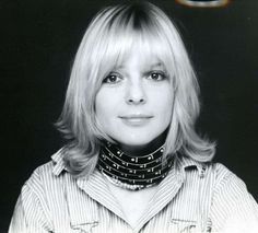 a black and white photo of a woman with blonde hair wearing a collared shirt