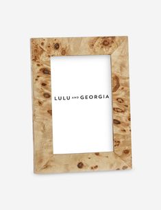 a wooden frame with the words lulu and georgia in black ink on it, against a white background