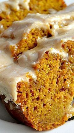 a close up of a piece of cake on a plate with icing and some carrots