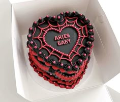 a heart shaped cake in a box with the words aries baby written on it