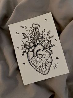 a drawing of a heart with flowers on it