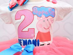 a peppa pig birthday outfit with pink tutu and blue bow