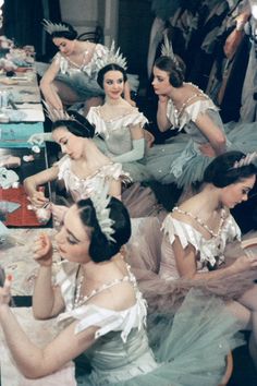 several women dressed in costumes sitting at a table