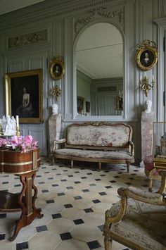 a living room filled with lots of furniture and mirrors on the wall next to each other