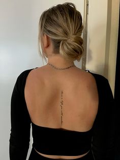 the back of a woman's neck with a tattoo on her left arm and chest