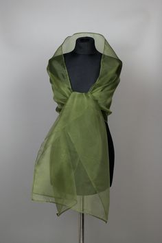 a mannequin with a green scarf on top of it