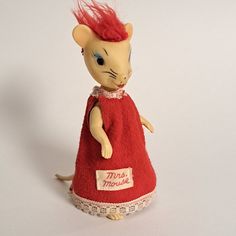 a toy mouse in a red dress on a white background with the words miss mouse written on it