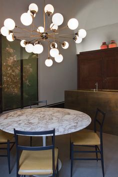 a dining room with a marble table and chairs