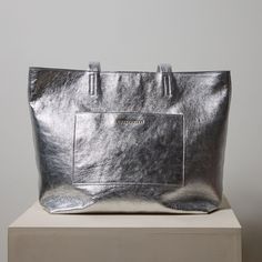 Silver Everyday Tote - Nickel & Suede Luxury Gray Shoulder Bag With Double Handle, Luxury Metallic Silver Shoulder Bag, Luxury Gray Bags With Leather Handles, Luxury Gray Bag With Palladium Hardware, Luxury Gray Bag With Removable Pouch, Luxury Gray Shoulder Bag With Palladium Hardware, Silver Tote Bag With Leather Handles, Silver Bags With Leather Handles For Daily Use, Chic Silver Shoulder Bag With Double Handle