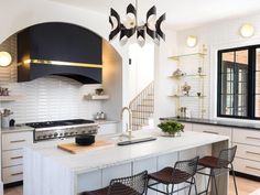 a kitchen with an island and stools in it