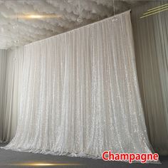 a large white curtain is hanging from the ceiling