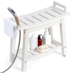 a white shower bench with soap and lotion on it