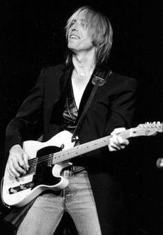 a man playing an electric guitar on stage