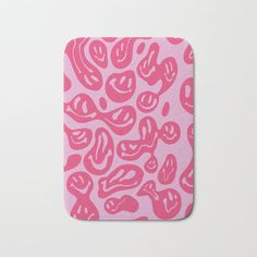 a pink and white animal print bath mat with hearts on it's back side