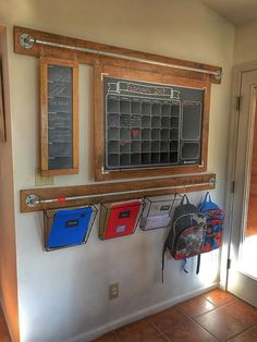 a chalkboard mounted to the side of a wall with school supplies hanging on it