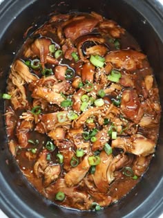 a slow cooker filled with meat and vegetables