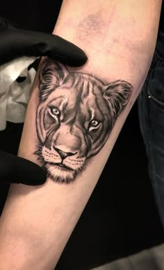 a woman's arm with a tiger tattoo on it