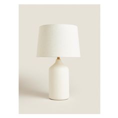 a white table lamp with a white shade on it's base and a beige linen lampshade