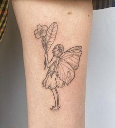 a small tattoo of a fairy holding a flower