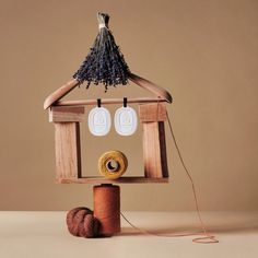 a wooden birdhouse with two tags on it