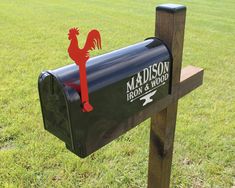 a mailbox with a red rooster on it