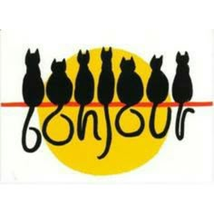 a group of cats sitting on top of a yellow and black sign that says bonjou