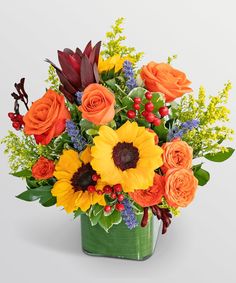 a vase filled with orange and yellow flowers