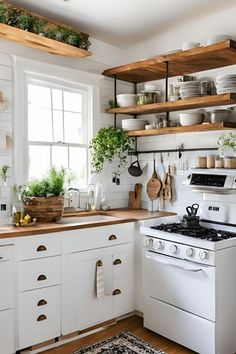 a white stove top oven sitting inside of a kitchen next to a counter with pots and pans on it