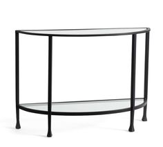 an oval glass table with metal legs and a shelf on the bottom that is black