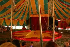 a circus tent with people sitting on the floor