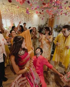 a group of people standing around each other in front of a man on the dance floor