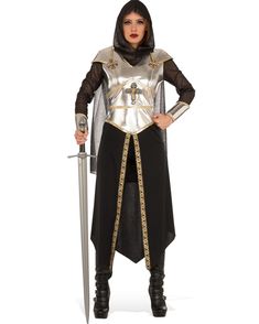 Item Includes: Dress. Hood with attached sleeves. Skirt with attached leggings. Fit and Sizing: See size chart image for details. Fabrics and Care: 100% Polyester. Hand wash, hang dry. Please note: Sword prop and shoes not included. I will protect my kingdom Transform into a brave woman of power, strength and respect in this Medieval Warrior Womens Costume. This costume includes a dress with a metallic silver mock armour plate with gold detailing and a cross embellishment on the front. The mock plate also features shoulder pads and ornate cross fastens on the shoulders. There is a woven fax silver chainmail hood and sleeves with attached silver gauntlets attached to the sleeves. The included black skirt features a gold embroidered edge with a centre slit, attached black leggings and an att Joan Of Arc Costume, Brave Women, Medieval Costume, Joan Of Arc, Costume Shop, Fancy Dress Costumes