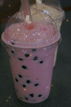 a pink drink with black dots and a straw in it