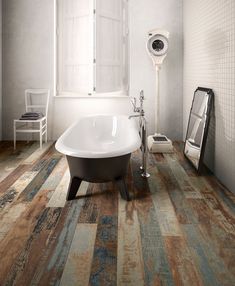 a bath tub sitting on top of a wooden floor