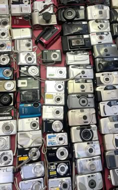 many different types of cameras are on display