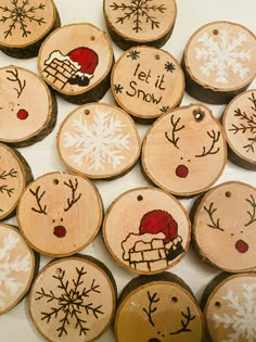 wood slices with painted snowflakes and words on them